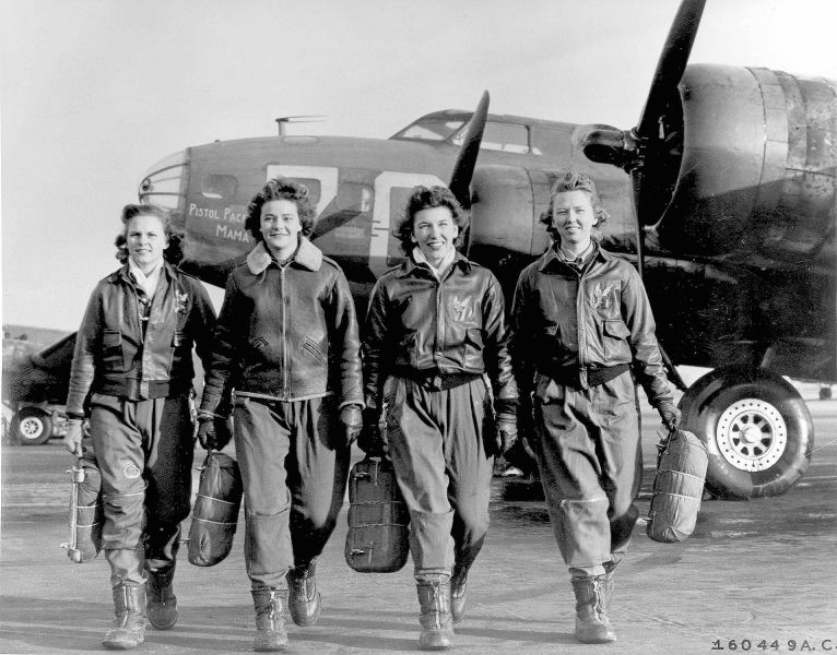 Four women walking away from airplanes